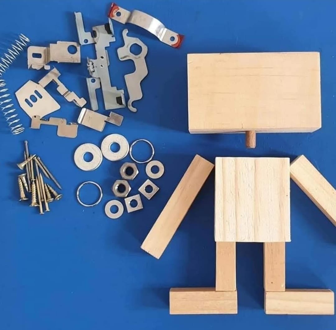 Wooden blocks laid out with screws, washers, nuts and salvaged metal parts on a blue surface