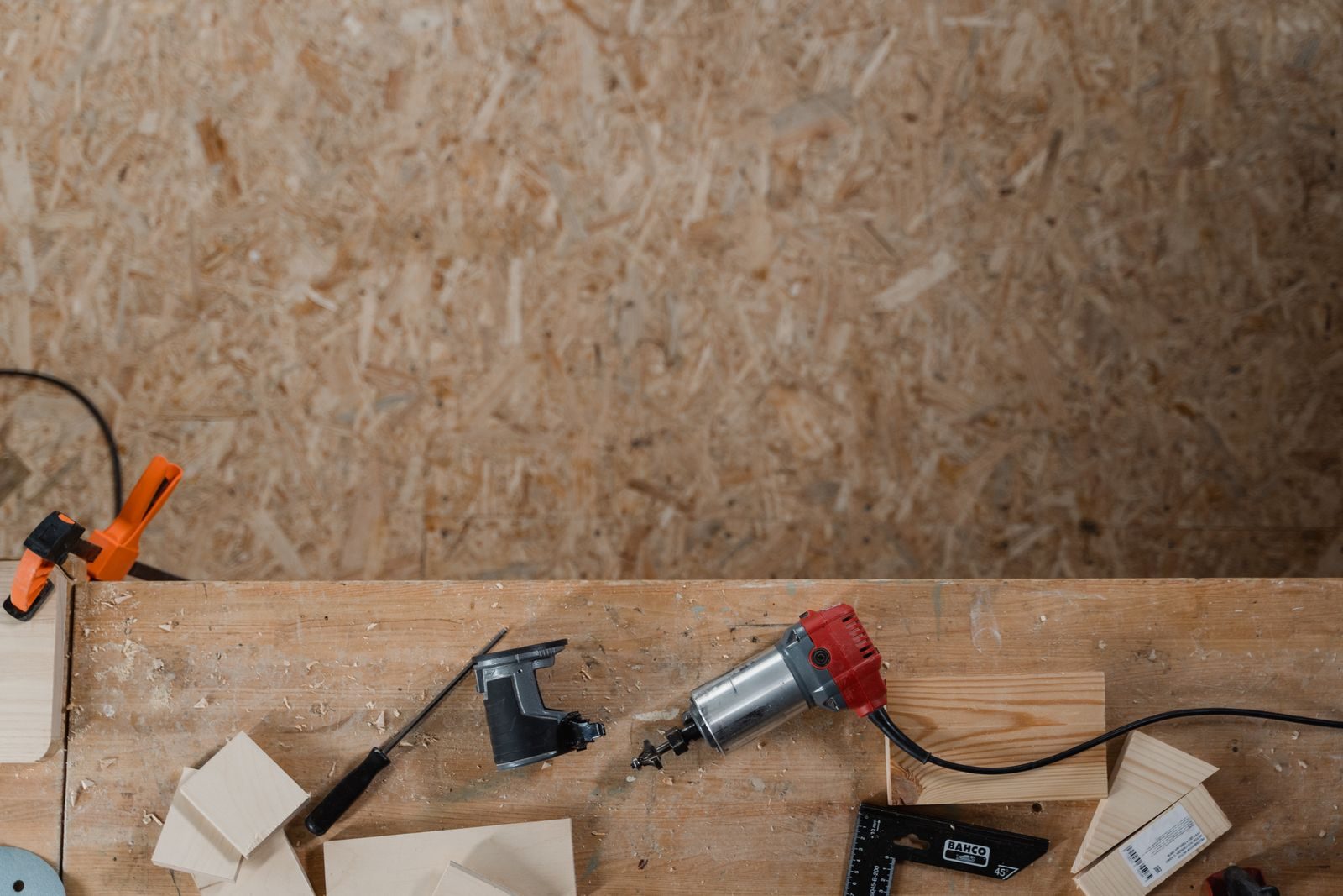 Overhead view of screwdrivers, clamps, fixings and offcuts on a board
